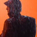 man in rain with black backpack on