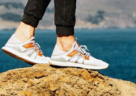 white sneakers on rock by the beach