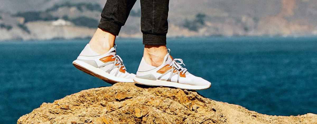 white sneakers on rock by the beach