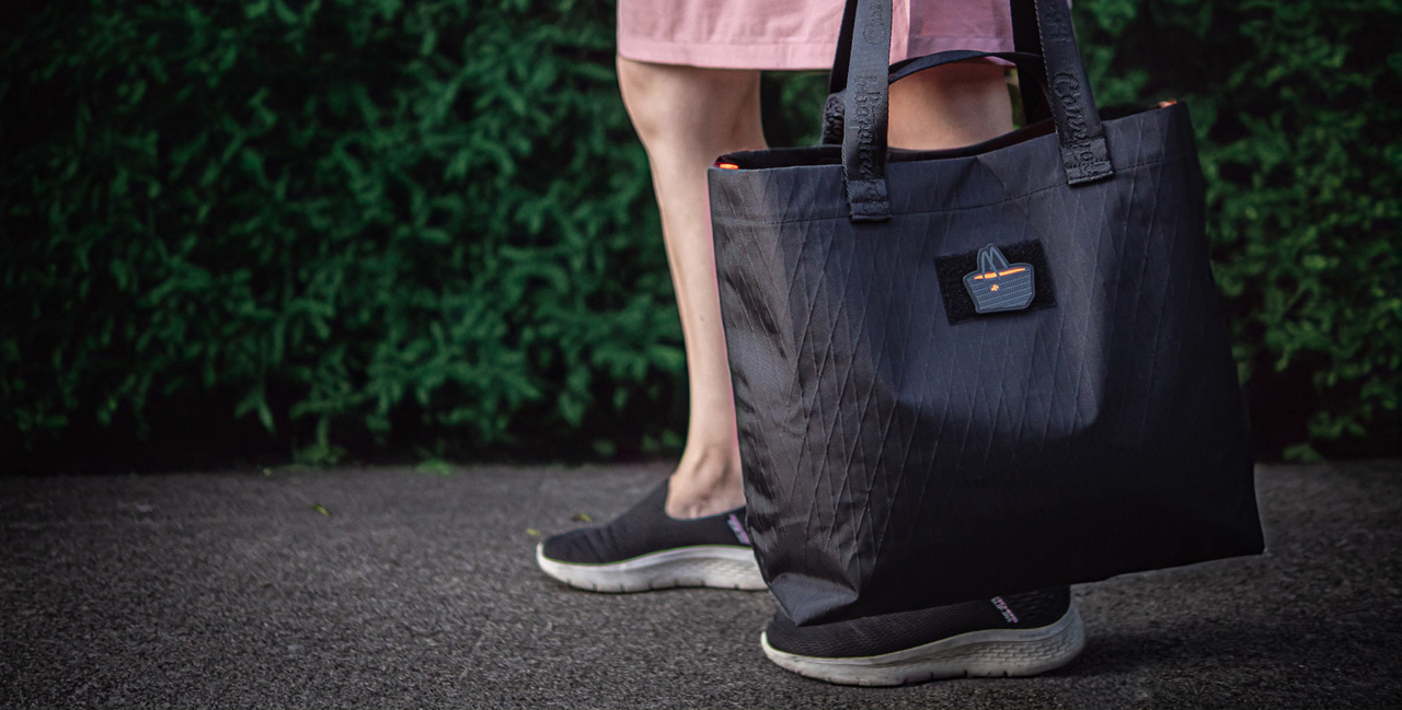 lady carrying black x-pac tote