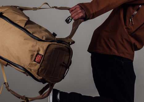 MAN RUNNING WITH COYOTE BROWN BACKPACK