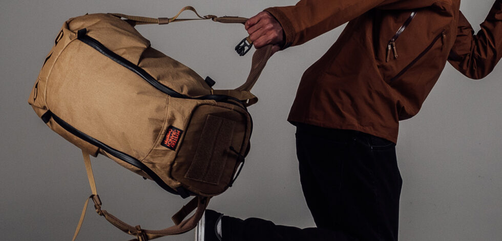 MAN RUNNING WITH COYOTE BROWN BACKPACK