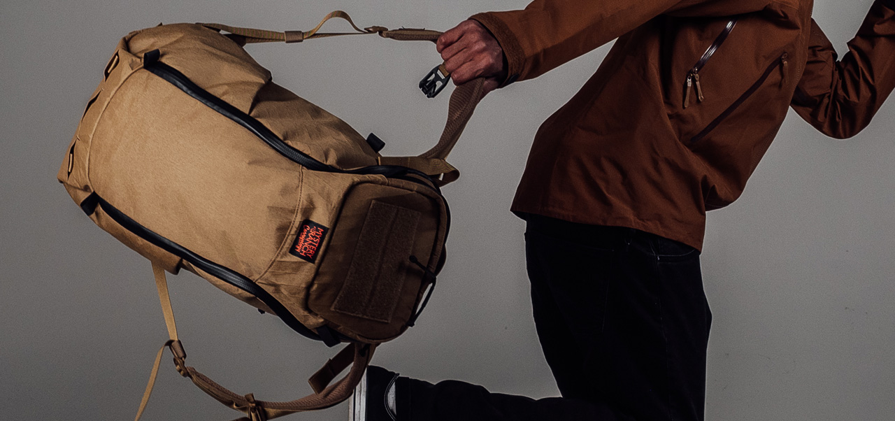 MAN RUNNING WITH COYOTE BROWN BACKPACK